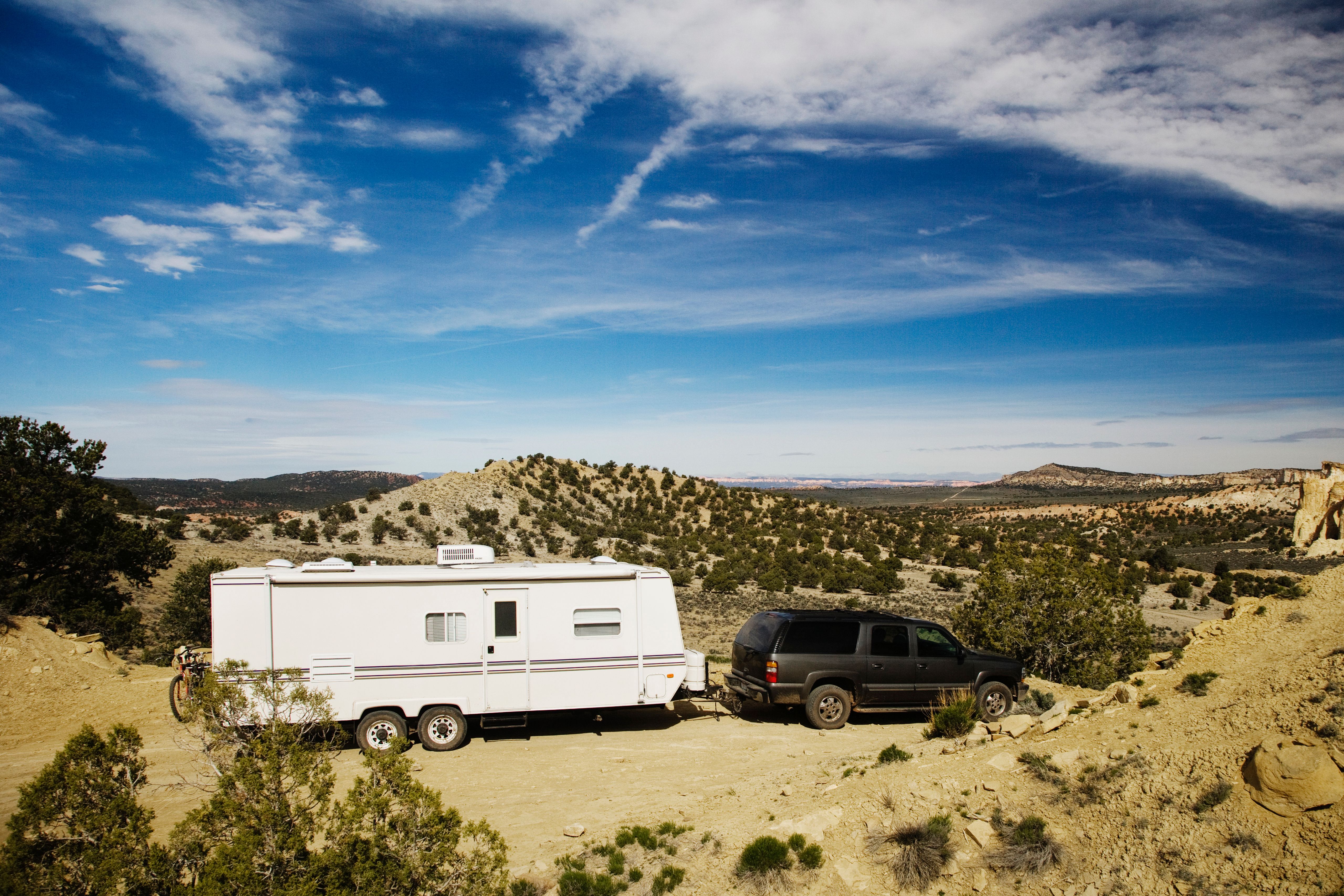 53788-car-pulling-trailer-in-desert-landscape-gra-2026-03-25-05-13-23-utc.